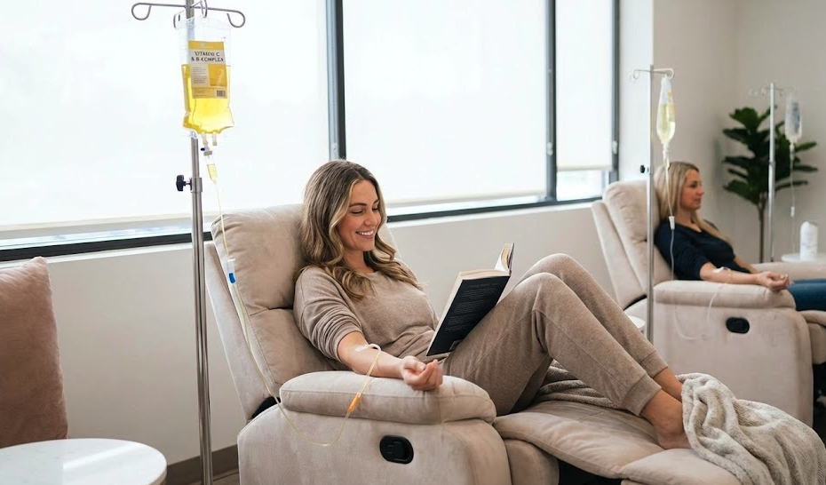 Patient relaxing in a recliner chair receiving IV vitamin therapy at a clinic